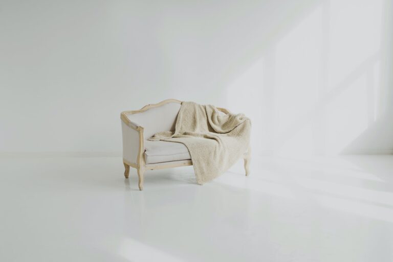 white towel on white wooden sofa